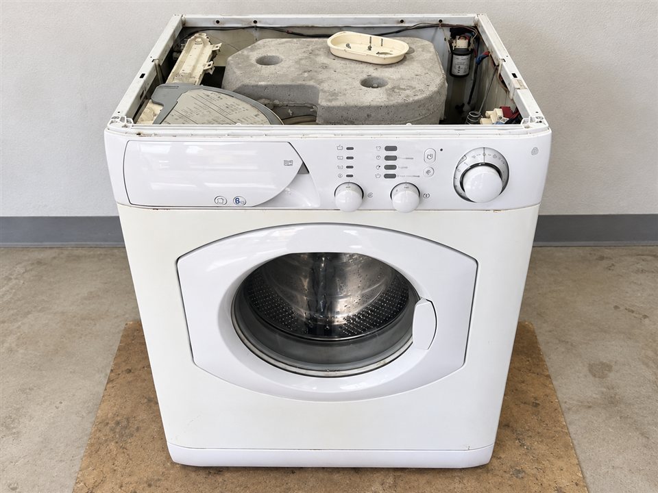 Open-top front-loading washing machine showing internal components